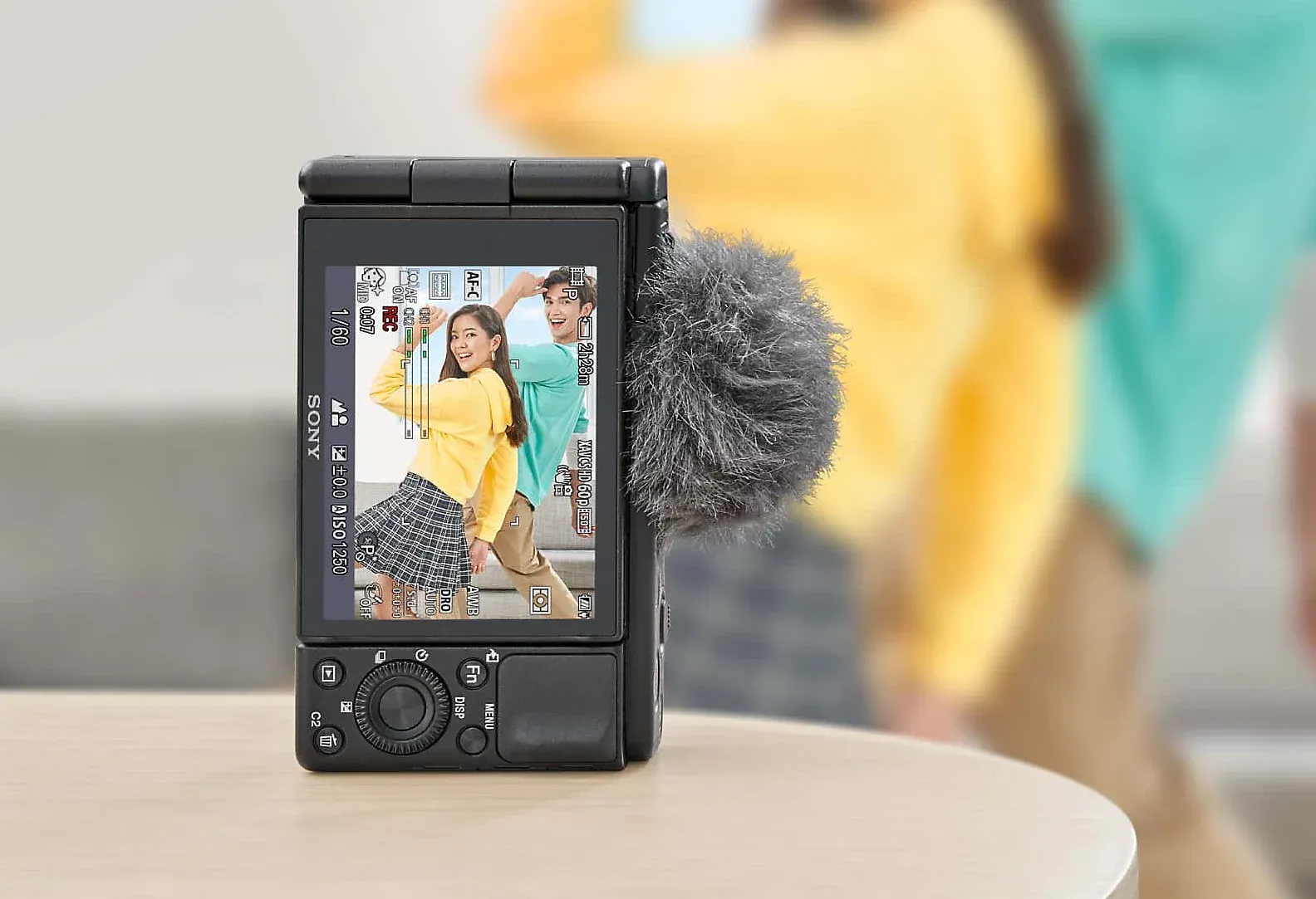 Sony ZV-1 vlogging camera capturing a woman in yellow