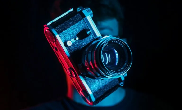 man playing with a camera in blue and red lighting
