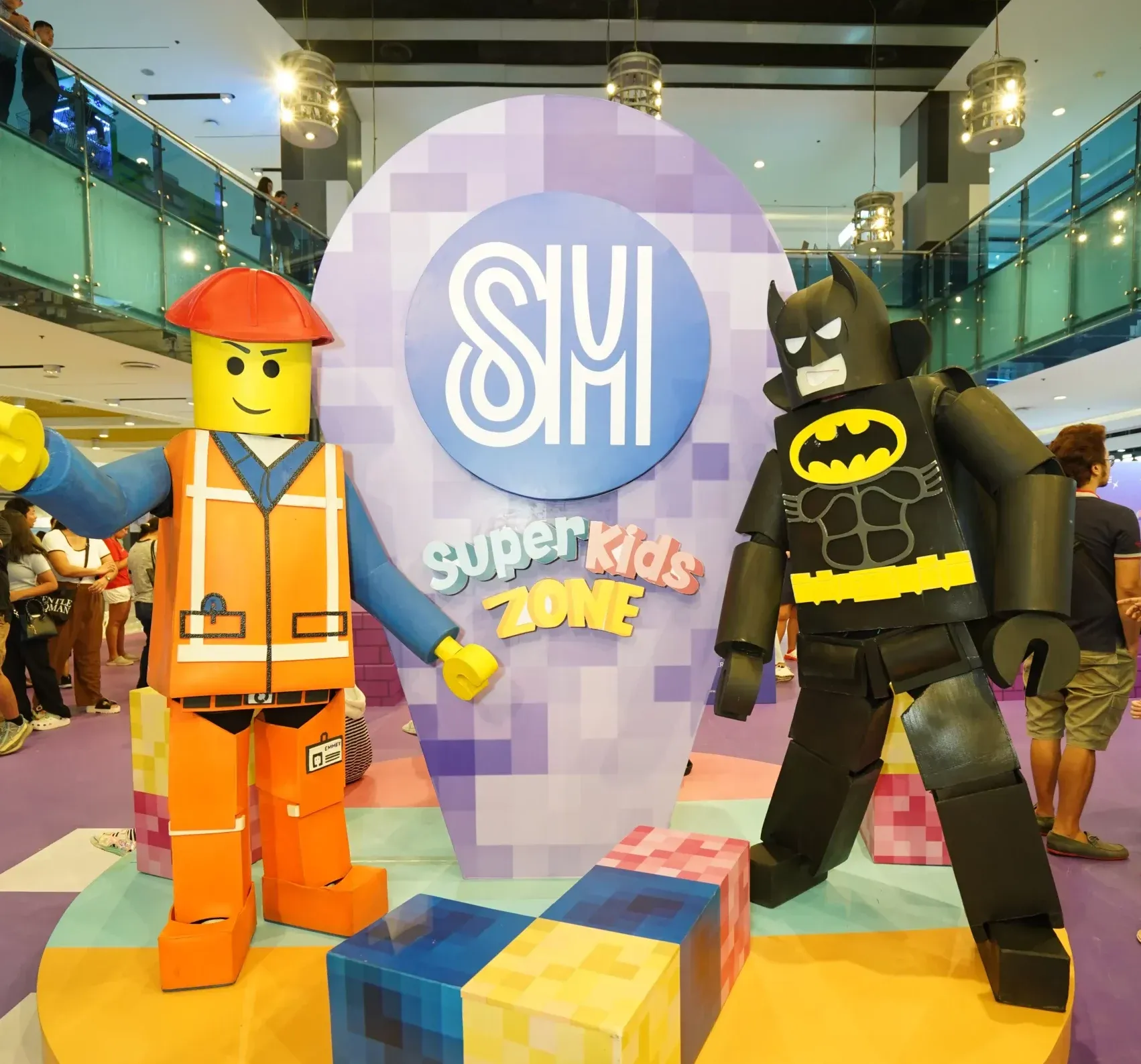Lego bat man and lego man in a booth inside a mall