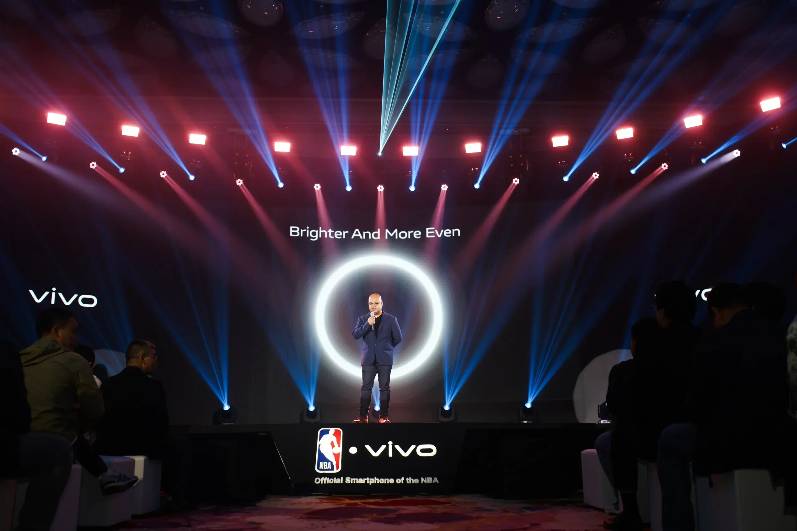Yuga tech founder on a stage with a white ring behind him