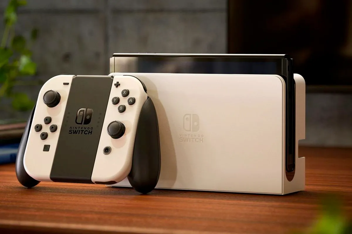 white nintendo switch oled on a wooden table