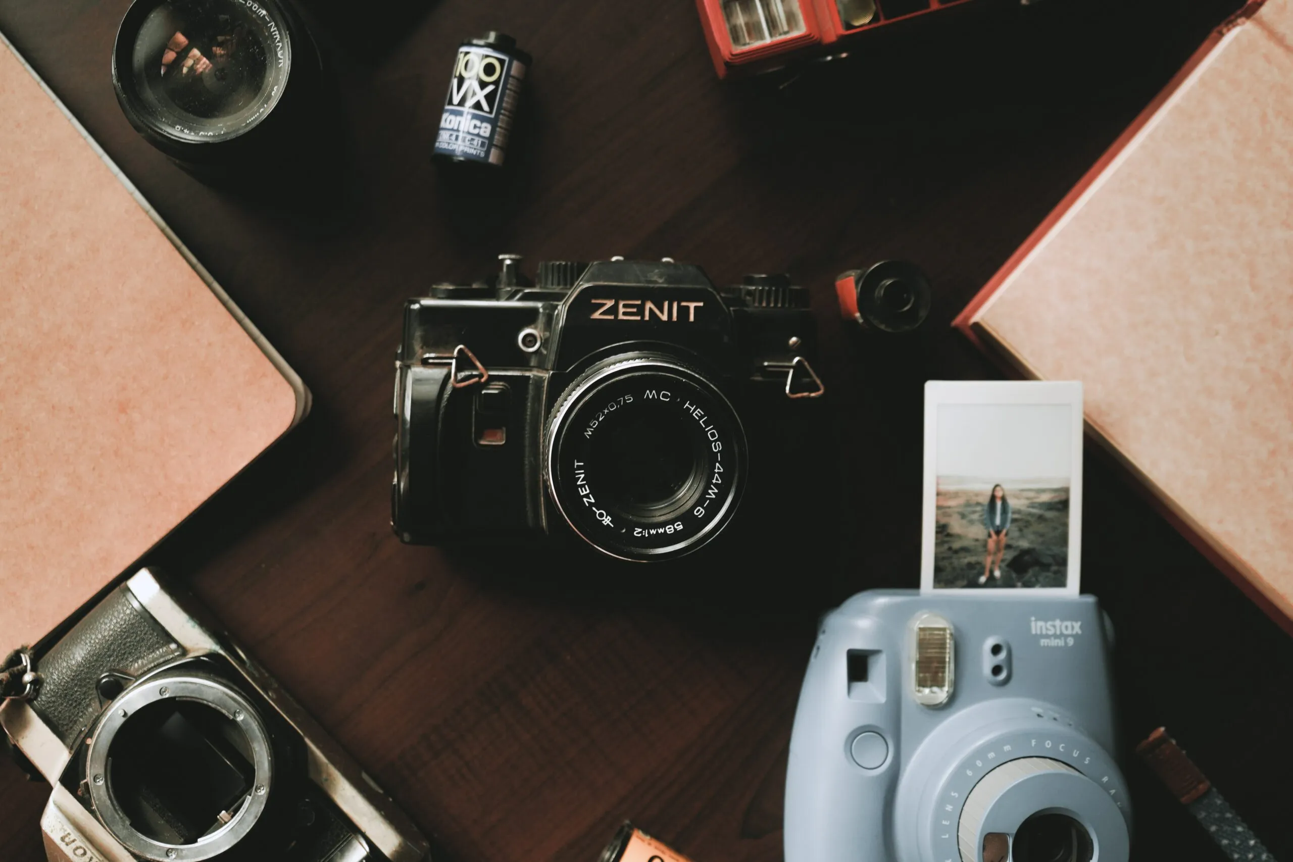 instant cameras, lomo, and film cameras on a a brown table