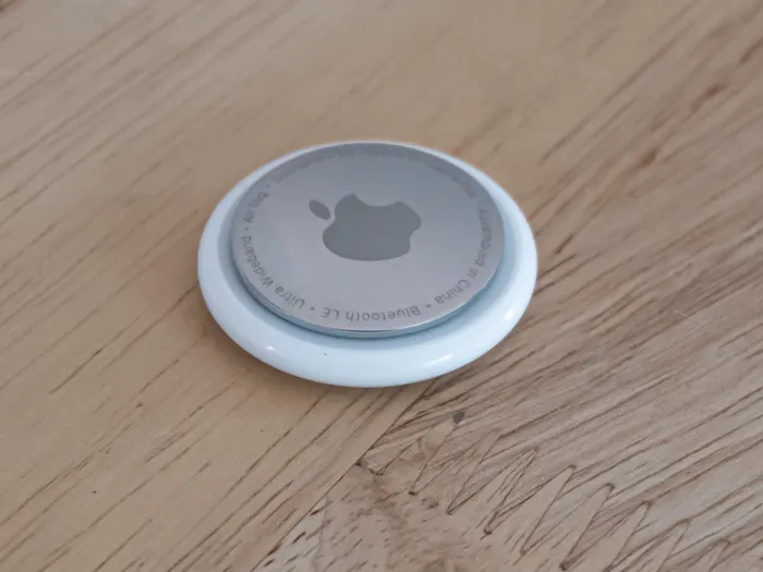 apple air tag on a wooden table