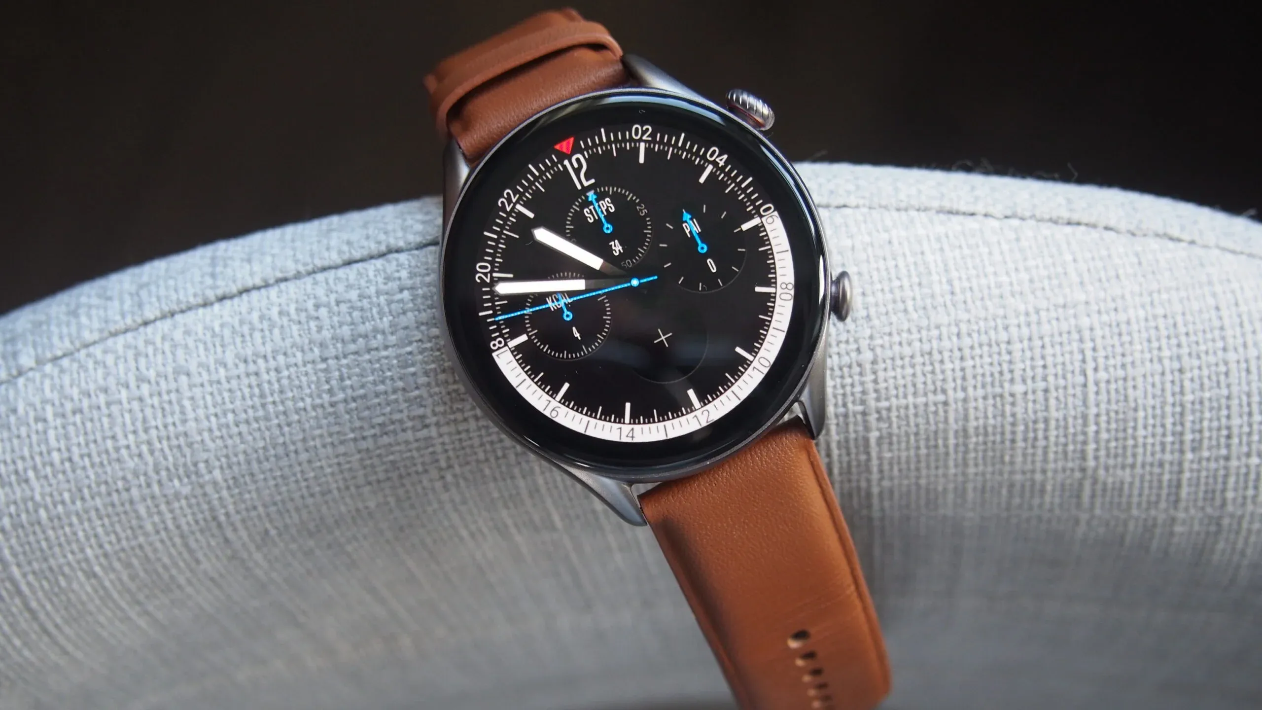 Amazfit GTR 3 Pro with brown bands on a cushion