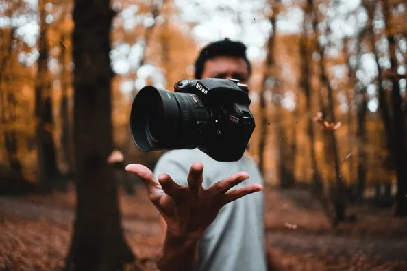 man holding a camera for photography trends