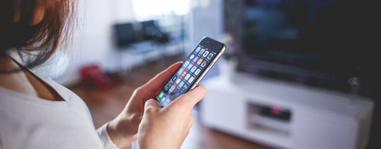 Woman using her phone to connect to her smart home