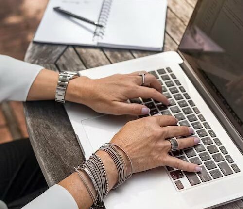 man typing on gaming laptops for work