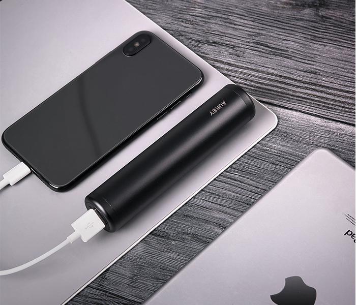 pen type lipstick size black powerbank connected to a phone